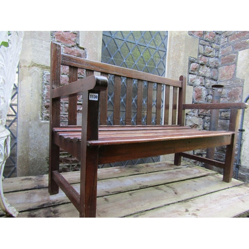 1130 - A small stained teak two seat garden bench with slatted seat and back, 120cm wide.