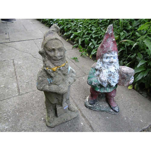 1136 - Two weathered cast composition stone garden gnomes in varying poses, approx 50 cm high  (af)