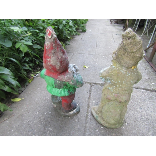 1136 - Two weathered cast composition stone garden gnomes in varying poses, approx 50 cm high  (af)