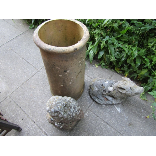 1155 - A weathered, buff coloured cylindrical chimney pot, 60 cm high together, with a cast composition sto... 