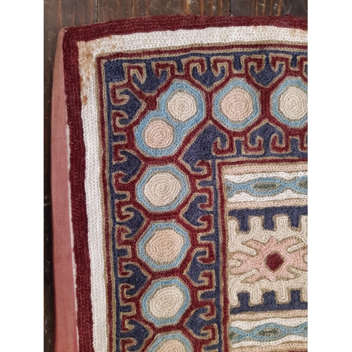 814 - Nepalese crewel work panel of colourful geometric design, backed with maroon cotton fabric, 125x180c... 