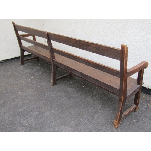 1671 - A long vintage stained pine chapel bench with triple railed back, open scrolled arms, tapered plank ... 