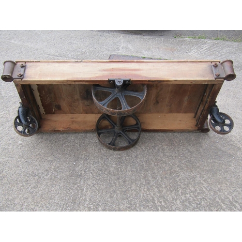 1675 - A vintage four-wheeled platform trolley, with hardwood boarded bed and cast iron fittings, (likely e... 