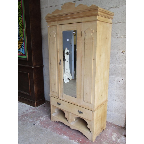 1697 - An Edwardian striped pine wardrobe enclosed by a three quarter length mirror panelled door, flanked ... 