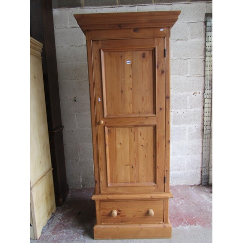 1698 - A reclaimed pine wardrobe enclosed by a three quarter length twin moulded panelled door over a long ... 