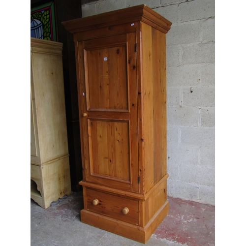 1698 - A reclaimed pine wardrobe enclosed by a three quarter length twin moulded panelled door over a long ... 