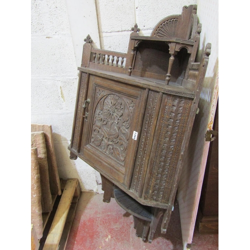 1704 - A late Victorian arts and crafts oak hanging corner cupboard, with well detailed and carved floral a... 