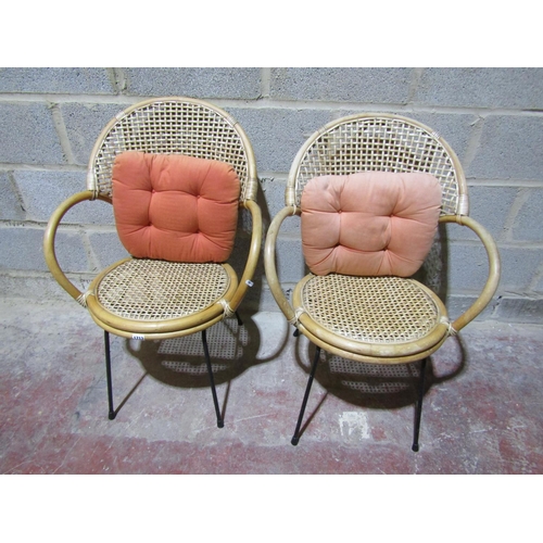 1713 - A pair of vintage cane chairs with lattice backs and circular seats raised on steel supports