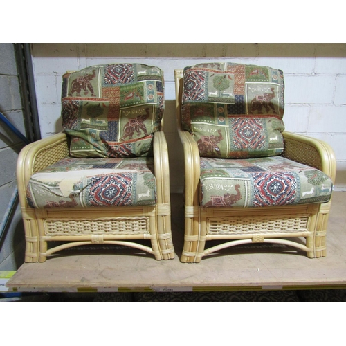 1715 - A pair of bound cane work conservatory chairs with loose cushions