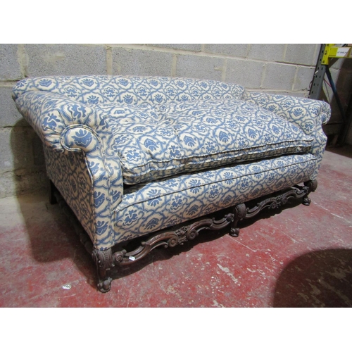 1716 - A 19th century two seat sofa with rolled arms, upholstered finish and deep feather filled loose seat... 