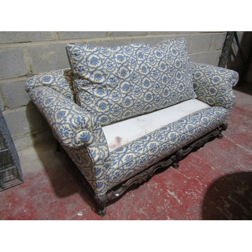 1716 - A 19th century two seat sofa with rolled arms, upholstered finish and deep feather filled loose seat... 