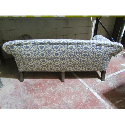 1716 - A 19th century two seat sofa with rolled arms, upholstered finish and deep feather filled loose seat... 