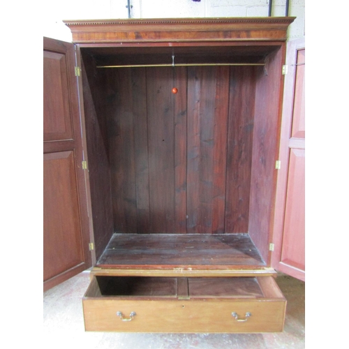 1727 - An Edwardian mahogany wardrobe in the Georgian style, enclosed by a pair of three quarter length mou... 