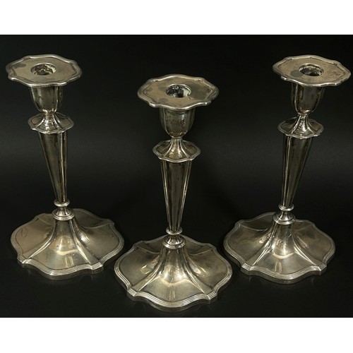 261A - Three Walker & Hall silver candlesticks on flared weighted bases, 24cm high