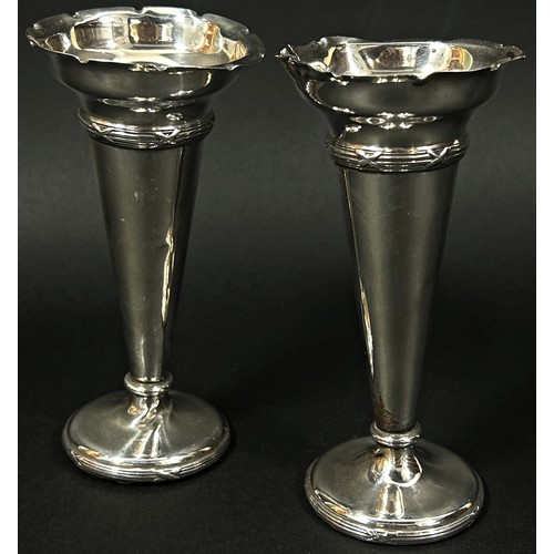 267 - A pair of Spink & Son miniature silver taper sticks and a pair of silver posy vases (weighted) 16oz ... 