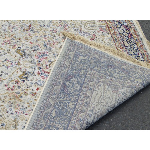 1777A - A Persian style carpet with an all over floral pattern on a cream ground 225cm x 153cm approximately