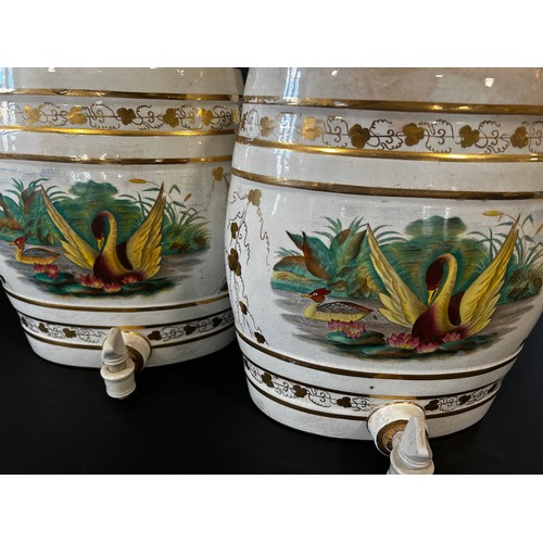 6 - A pair of decorative ceramic spirit barrels with gilt borders and painted pond side vignettes (conve... 