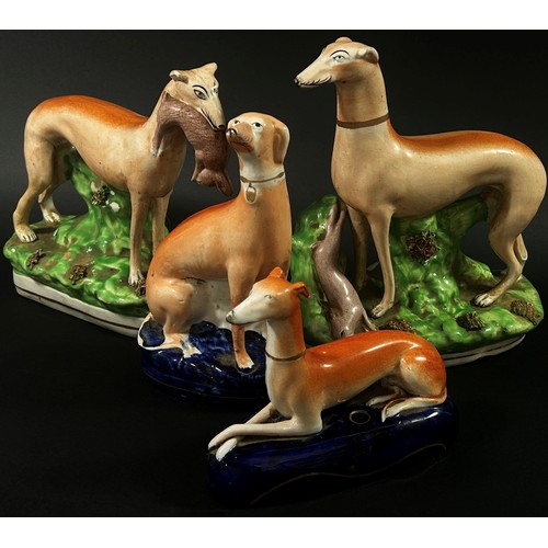 31 - Four Staffordshire greyhound models, the largest 24 cm high (4)