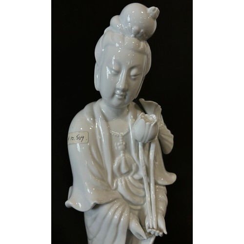 39 - A large Chinese blanc de chine figure of Guaynin, presented standing upon a Lotus pad, clutching Lot... 