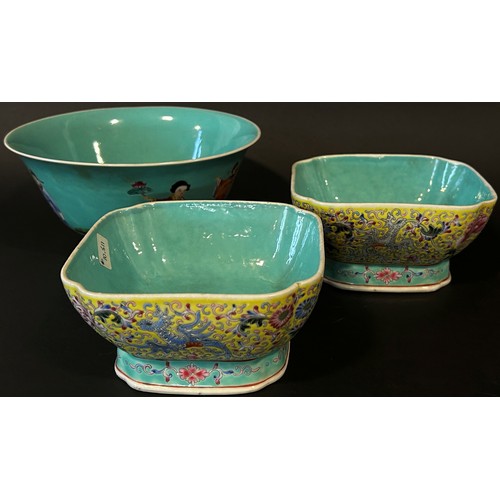 47 - A pair of Chinese enamelled porcelain square footed bowls of squared form, decorated with mythical b... 