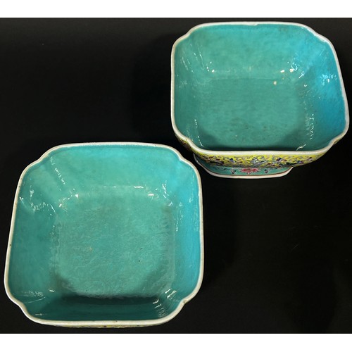 47 - A pair of Chinese enamelled porcelain square footed bowls of squared form, decorated with mythical b... 