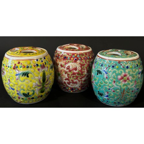 48 - A trio of Chinese export porcelain lidded jars of cylindrical form in shades of yellow, green and re... 