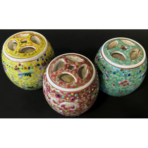 48 - A trio of Chinese export porcelain lidded jars of cylindrical form in shades of yellow, green and re... 