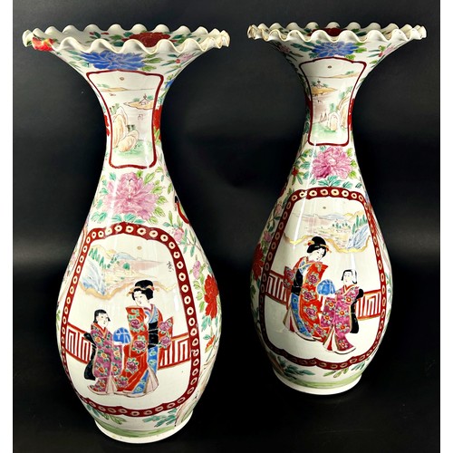 46 - A pair of Japanese export porcelain vases decorated with figures, within vignettes, with floral bord... 