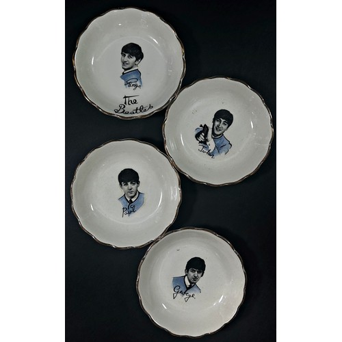 28 - A set of four collectible porcelain dishes each decorated with a portrait of the four members of The... 