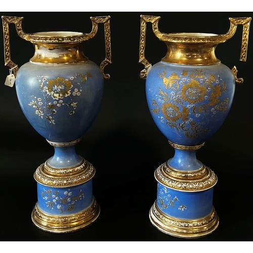 25 - A large and impressive pair of English Empire Porcelain Co twin handled urn shaped vases raised on c... 