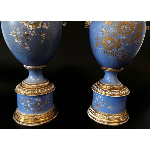 25 - A large and impressive pair of English Empire Porcelain Co twin handled urn shaped vases raised on c... 