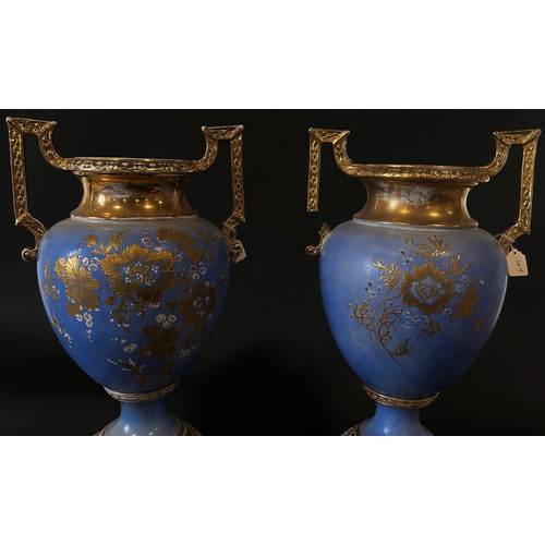 25 - A large and impressive pair of English Empire Porcelain Co twin handled urn shaped vases raised on c... 