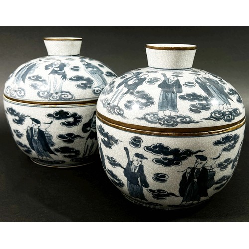 36 - A pair of Chinese blue and white porcelain jars and covers of cylindrical form, decorated throughout... 