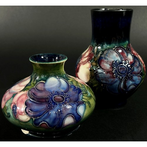 64 - A small  Moorcroft pottery vase of tapering baluster form with floral motifs, labelled to underside ... 