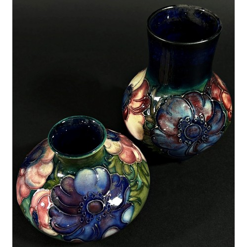 64 - A small  Moorcroft pottery vase of tapering baluster form with floral motifs, labelled to underside ... 