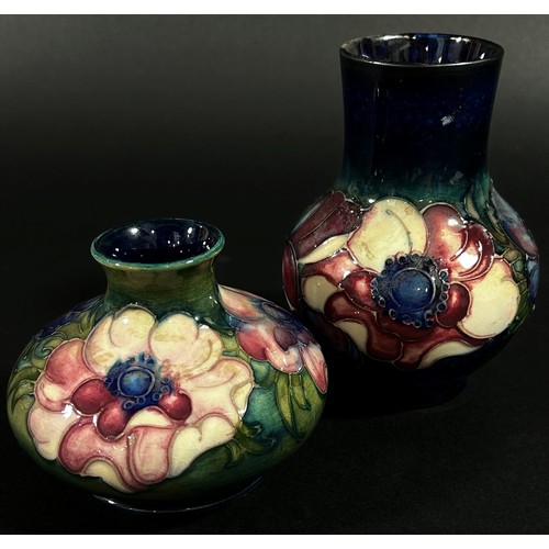 64 - A small  Moorcroft pottery vase of tapering baluster form with floral motifs, labelled to underside ... 