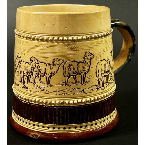 60 - In the style of Hannah Barlow for Doulton Lambeth, a stoneware tankard decorated with incised centra... 