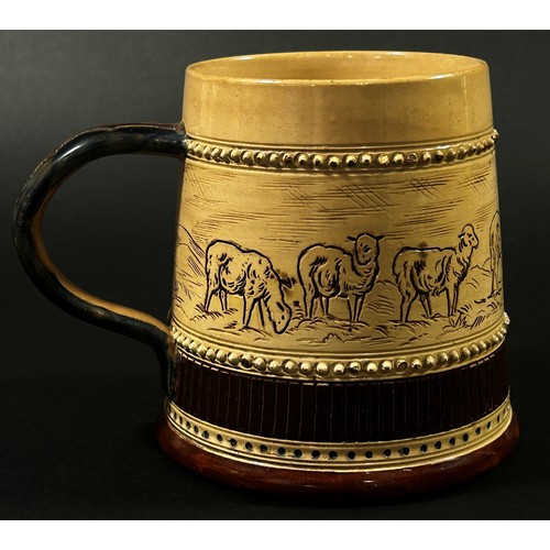 60 - In the style of Hannah Barlow for Doulton Lambeth, a stoneware tankard decorated with incised centra... 