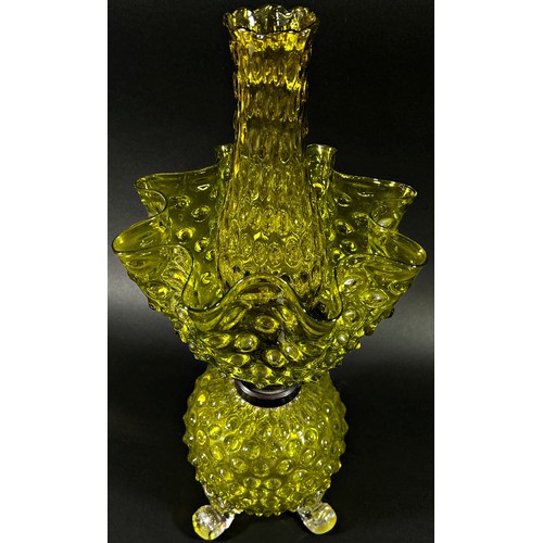 143 - A decorative Victorian yellow glass oil lamp with nobbled globular bowl raised on scrolled legs with... 