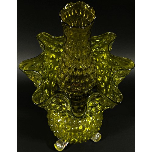 143 - A decorative Victorian yellow glass oil lamp with nobbled globular bowl raised on scrolled legs with... 