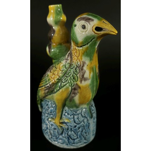 77 - A Chinese earthenware water dropper in Sancai type glaze in the form of a seated stylised bird, 13 c... 