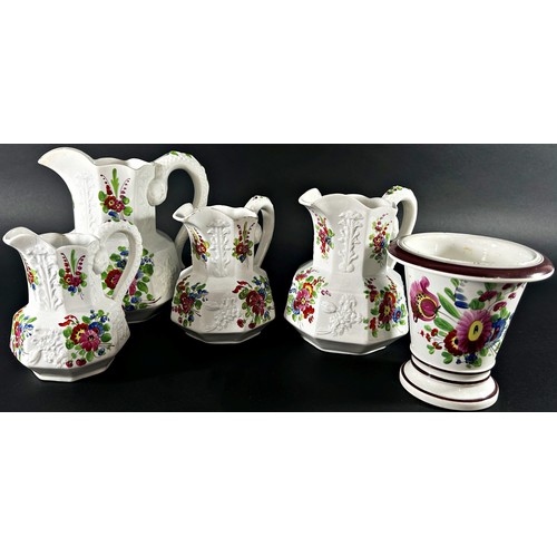 89 - A graduated set of four moulded Bristol pottery jugs with serpent handles and hand painted floral sp... 