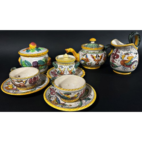 103 - A small group of continental faience glazed items to include teapot, jug, dishes, two tea cups, lidd... 