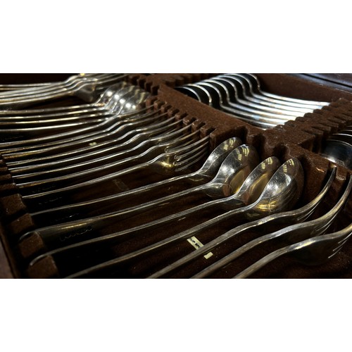 173 - A mahogany canteen containing silver plated and stainless steel cutlery