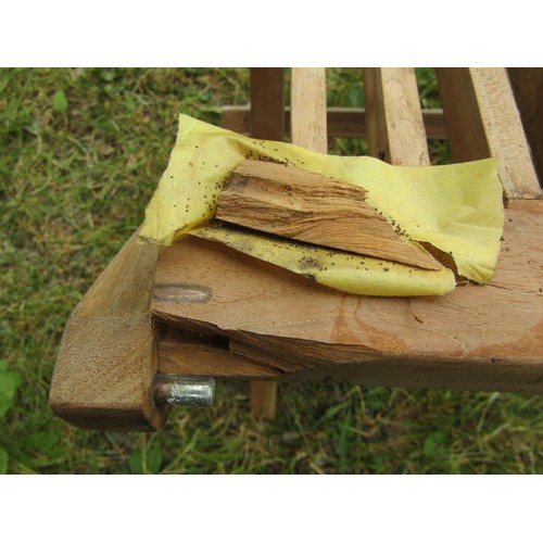 1157 - A weathered circular folding teak garden table with slatted panelled top, 120cm diameter together  w... 