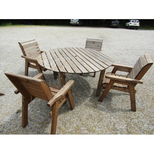 1161 - A weathered rustic five piece garden suite compris8ing circular top table and four open armchairs wi... 