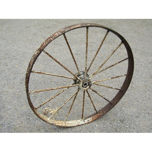 1164 - A pair of antique painted and weathered cast iron implement wheels 118 cm diameter