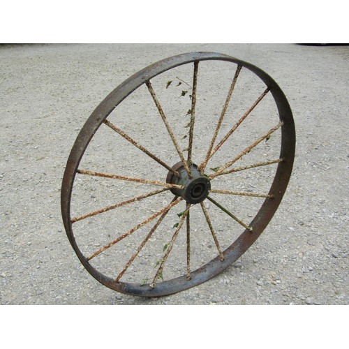 1164 - A pair of antique painted and weathered cast iron implement wheels 118 cm diameter