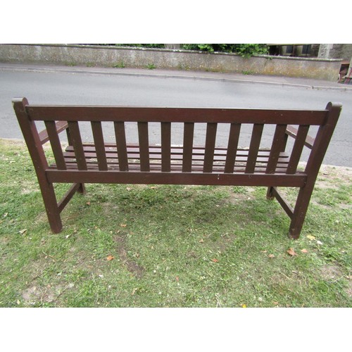 1182 - A vintage stained teak three seat garden bench with slatted seat and back, 159 cm long (af)