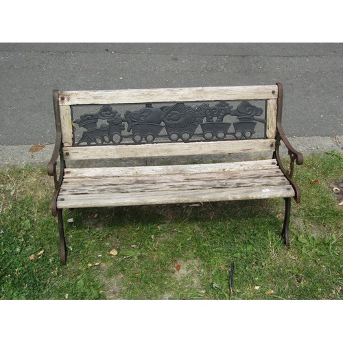 1183 - A child's size weathered garden bench with cast iron panelled back and end supports, 83 cm long (af)